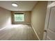 Bright bedroom with laminate floors and view of the outdoors through the window at 6705 Somerknoll Dr, Durham, NC 27713