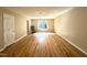 Large bonus room featuring vinyl floors, window, and doors at 6705 Somerknoll Dr, Durham, NC 27713