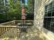 Wooden deck with a seating area and a striped umbrella, perfect for outdoor relaxation at 6705 Somerknoll Dr, Durham, NC 27713