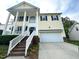 Two-story home with white columns, a large arched window, and a well-maintained front yard at 6705 Somerknoll Dr, Durham, NC 27713