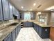 A well designed kitchen featuring painted cabinets, granite countertops, and stainless steel appliances at 6705 Somerknoll Dr, Durham, NC 27713
