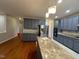 Well lit kitchen with stainless steel appliances, painted cabinets and granite countertops at 6705 Somerknoll Dr, Durham, NC 27713