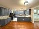 Well lit kitchen with stainless steel appliances, granite countertops and hardwood floors at 6705 Somerknoll Dr, Durham, NC 27713