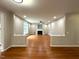 Open living room with hardwood floors, fireplace, and lots of natural light at 6705 Somerknoll Dr, Durham, NC 27713