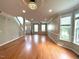 Open-concept living space features hardwood floors, recessed lights and a large window at 6705 Somerknoll Dr, Durham, NC 27713