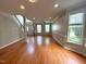 Open living room with hardwood floors and plenty of natural light at 6705 Somerknoll Dr, Durham, NC 27713