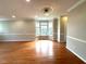 Living room features hardwood floors, natural light, neutral paint, and decorative crown molding at 6705 Somerknoll Dr, Durham, NC 27713
