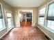 Bright sunroom leading to the kitchen, surrounded by windows, providing natural light at 6705 Somerknoll Dr, Durham, NC 27713