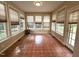 Bright sunroom surrounded by windows, providing natural light and a view of the outdoors at 6705 Somerknoll Dr, Durham, NC 27713
