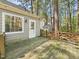 Back deck with lush green surroundings and white trim door at 7117 Sandringham Dr, Raleigh, NC 27613