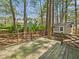 Back deck with lush green surroundings and chicken coop in distance at 7117 Sandringham Dr, Raleigh, NC 27613