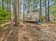 Backyard showing a deck, trees, and a shed at 7117 Sandringham Dr, Raleigh, NC 27613