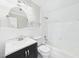 Elegant bathroom features a modern vanity with sink, mirror, and tub/shower combination with white tile at 7117 Sandringham Dr, Raleigh, NC 27613