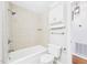 Bright bathroom features a shower-over-tub combination with tiled surround and modern white vanity storage at 7117 Sandringham Dr, Raleigh, NC 27613