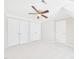 Light and airy bedroom features ceiling fan, neutral carpet and paint, and three spacious closets at 7117 Sandringham Dr, Raleigh, NC 27613