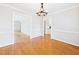 Bright dining room showcases hardwood floors and easy access to multiple rooms at 7117 Sandringham Dr, Raleigh, NC 27613