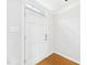 Bright entryway with a white front door, hardwood floors, and clean, neutral walls at 7117 Sandringham Dr, Raleigh, NC 27613