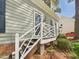 Close-up of the front porch, showcasing the decorative white railing, steps, and welcoming entry at 7117 Sandringham Dr, Raleigh, NC 27613