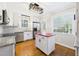 Well-lit kitchen boasts stainless steel appliances, white cabinetry, and a center island at 7117 Sandringham Dr, Raleigh, NC 27613