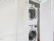 Stacked washer and dryer in a closet with bifold doors offers space-saving laundry solution at 7117 Sandringham Dr, Raleigh, NC 27613