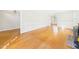 Open-concept living room with hardwood floors and classic white trim and fireplace at 7117 Sandringham Dr, Raleigh, NC 27613