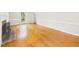 Sunlit living room with hardwood floors, large windows, and a charming fireplace at 7117 Sandringham Dr, Raleigh, NC 27613
