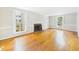Spacious living room with hardwood floors, fireplace, and large windows offering ample natural light at 7117 Sandringham Dr, Raleigh, NC 27613