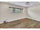 A bedroom with modern wood flooring, a ceiling fan and a large window at 717 E Millbrook Rd, Raleigh, NC 27609
