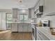 Modern kitchen featuring stainless steel appliances, gray cabinets, and a bright window at 717 E Millbrook Rd, Raleigh, NC 27609