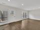 Spacious living room with wood floors, large windows, and natural light at 717 E Millbrook Rd, Raleigh, NC 27609