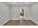 An open-concept living room featuring modern wood floors and access to the kitchen at 717 E Millbrook Rd, Raleigh, NC 27609