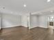 Bright living room with recessed lighting, wood floors, and a view into the kitchen at 717 E Millbrook Rd, Raleigh, NC 27609