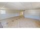 View of the basement with tiled floors, neutral color walls, and natural light at 72 Edgemont Ave, Roxboro, NC 27573