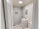 View of a bathroom featuring a tiled shower with a decorative accent and a modern vanity at 72 Edgemont Ave, Roxboro, NC 27573