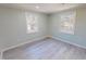 Well-lit bedroom showcasing modern flooring, two windows, and neutral wall color at 72 Edgemont Ave, Roxboro, NC 27573