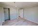 Bedroom featuring modern wood floors and a closet near an open doorway at 72 Edgemont Ave, Roxboro, NC 27573