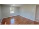 Bedroom with a glossy wood floor and natural light coming in through a window at 72 Edgemont Ave, Roxboro, NC 27573