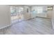 Open-concept kitchen with stainless steel appliances, white cabinetry, and sliding glass door to a deck at 72 Edgemont Ave, Roxboro, NC 27573