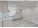 Bright kitchen features white cabinets, modern countertops, and gray backsplash at 72 Edgemont Ave, Roxboro, NC 27573