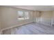 Bright living room featuring new flooring, fresh paint, and large windows at 72 Edgemont Ave, Roxboro, NC 27573