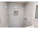 Close-up of the tiled shower, showcasing the decorative accent and modern fixtures at 72 Edgemont Ave, Roxboro, NC 27573