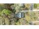 Aerial view of the home surrounded by mature trees, showcasing its layout and neighborhood setting at 7317 Mill Ridge Rd, Raleigh, NC 27613