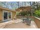 Spacious back deck perfect for outdoor lounging with an umbrella-covered table and chairs, leading to glass doors at 7317 Mill Ridge Rd, Raleigh, NC 27613