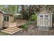 Backyard featuring wood deck with furniture and a utility shed with a ramp, all surrounded by mature trees at 7317 Mill Ridge Rd, Raleigh, NC 27613