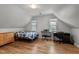 Spacious attic bedroom with hardwood floors, a desk, and two windows, offering a cozy and private space at 7317 Mill Ridge Rd, Raleigh, NC 27613