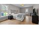 Bright bedroom with wood floors, large windows, and a comfortable bed, offering a serene and inviting space at 7317 Mill Ridge Rd, Raleigh, NC 27613