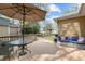Cozy outdoor deck with table, patio furniture, and an umbrella, perfect for relaxing or entertaining in the backyard at 7317 Mill Ridge Rd, Raleigh, NC 27613