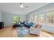 Open living area with natural light, showcasing a stylish blue sofa and patterned rug, ideal for comfortable living at 7317 Mill Ridge Rd, Raleigh, NC 27613