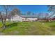 The home's backyard has a deck, a lush lawn, and mature trees with a shed at 772 Old Allensville, Roxboro, NC 27574