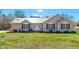 Charming single-story home with metal roof, complemented by a lush green lawn and manicured garden at 772 Old Allensville, Roxboro, NC 27574